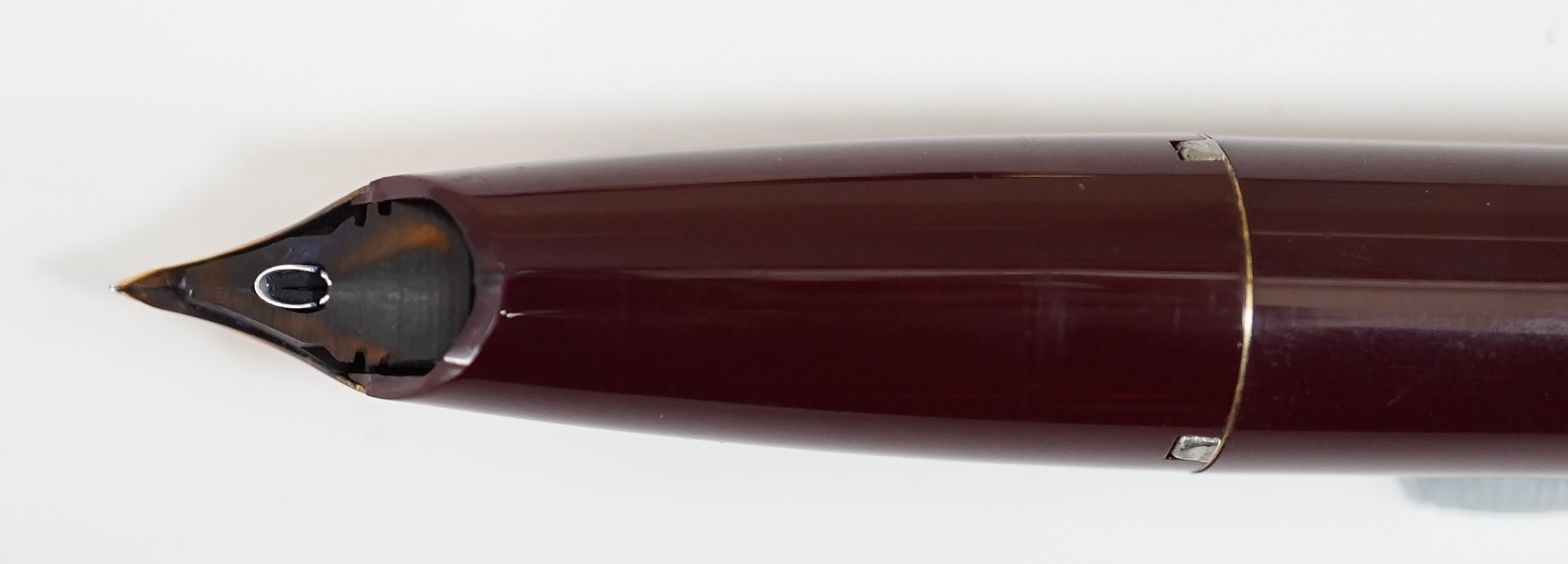 A Sheaffer PFM fountain pen in burgundy, with factory chalk marks to barrel